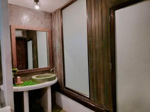 a bathroom with a sink and a mirror at THANSILA Resort in Ranong