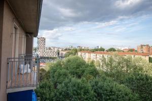 - un balcon dans un bâtiment avec des arbres et des bâtiments dans l'établissement Grazioso appartamento in Bicocca con AC e Wi-fi, à Milan