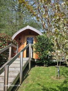 a small wooden cabin with a ramp leading to it at Mountain Edge Resort Mega pod 1 in Church Stretton