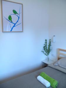 a bedroom with a bed with a green towel on it at Guesthouse Bor Plitvice Lakes in Plitvička Jezera