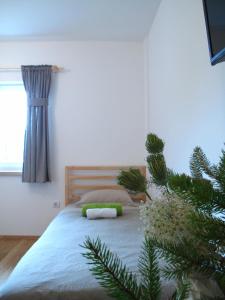 a bedroom with a bed with a christmas tree next to it at Guesthouse Bor Plitvice Lakes in Plitvička Jezera