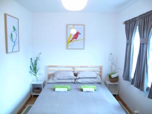 a bedroom with a large bed with two pillows at Guesthouse Bor Plitvice Lakes in Plitvička Jezera
