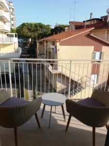 two chairs and a table on a balcony at Casalina in Lido di Jesolo