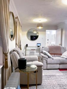 a living room with two couches and a table at Immaculate 2-Bed Apartment in Rochester in Rochester