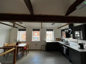 a kitchen and dining room with a table and chairs at The Fish Loft in Tewkesbury