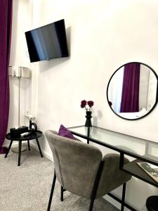 a room with a glass table and a mirror at Bed & Breakfast Donji Grad in Zagreb