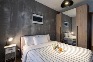 a bedroom with a bed with a tray of food on it at Casa del Sole - Free Parking in Rome