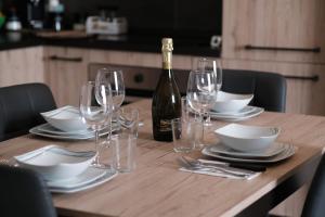 a wooden table with glasses and a bottle of wine at OdeMar Apartment in Pozzuoli +31 photos