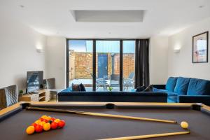 a living room with a pool table and a couch at Luxurious 5 Bed House in London - Pool Table in West Dulwich