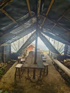 a long wooden table in a blue tent with benches at Eco Lodge Haputale-Camping Sri lanka in Haputale