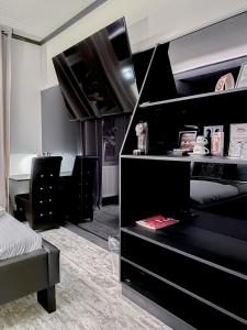 a bedroom with a bunk bed with black furniture at Boutique Hotel Schulz Classic in Neustadt am Rübenberge