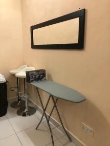 a table in a room with a mirror on the wall at Azaliza Homestay in Ayer Keroh