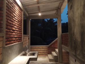 a bathroom with a sink and a window at The Brick Wonder in Habaraduwa Central