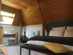a bedroom with a large bed with a wooden ceiling at chambre de madel in Domme
