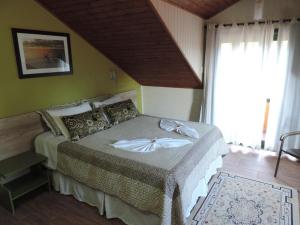 Un pat sau paturi într-o cameră la Pousada da Baronesa