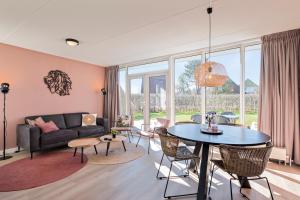een woonkamer met een tafel en een bank bij Summio Vakantiepark Emslandermeer in Vlagtwedde