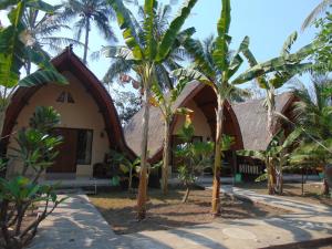 a house with a bunch of trees in front of it at Ings Garden in Gili Air