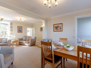 a dining room and living room with a table and chairs at 3 Bed in Brixham BX007 in Brixham