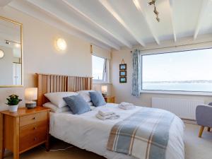 a bedroom with a bed and a large window at 3 Bed in Brixham BX007 in Brixham