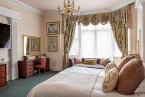 a bedroom with a bed and a chair and a window at The Lookout Rye in Rye