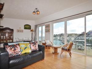 a living room with a black leather couch and a table at 2 Bed in Brixham BX026 in Brixham