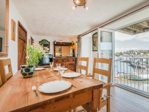 a dining room with a table and a large window at 2 Bed in Brixham BX026 in Brixham