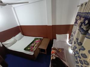 Postelja oz. postelje v sobi nastanitve Hotel Sai Aman