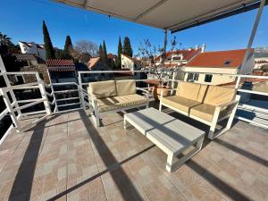 a patio with two chairs and a bench on a balcony at Studios in old town in Split