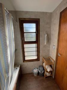 a bathroom with a tub and a window at Casa Zona Barrio Los Acantilados para alquiler temporario in Mar del Plata