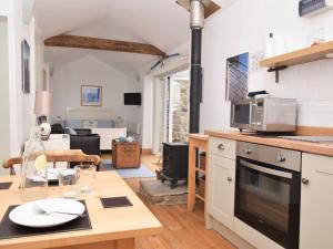 a kitchen with a table and a living room at 1 Bed in Nr Bamburgh CN002 in Lucker