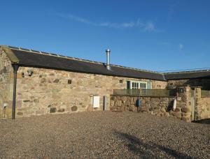 an old stone building with a window and a roof at 1 Bed in Nr Bamburgh CN002 in Lucker