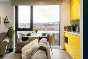 a living room with a couch and a table at Brand New Studio Apartment in Sheffield in Sheffield