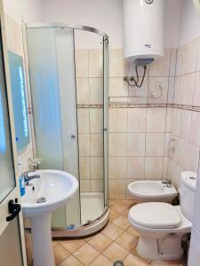 a bathroom with a shower and a toilet and a sink at Renata Seaview Apartment 310 in Durrës