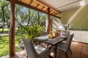 a table and chairs on a patio with a kitchen at Mauna Lani Fairways 302 in Waikoloa