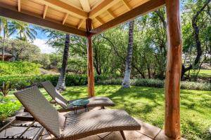 a patio with two chairs and a table at Mauna Lani Fairways 302 in Waikoloa +46 photos