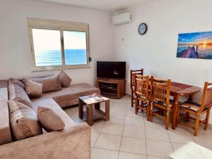 a living room with a couch and a table at Renata Seaview Apartment 310 in Durrës