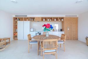 a kitchen and dining room with a table and chairs at Quinta do Pinhô - The Poolhouse in Salzedas