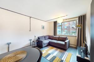 a living room with a couch and a table at Stunning 1 BD apartment for 3 people in Hackney with Japanese-style bath in London