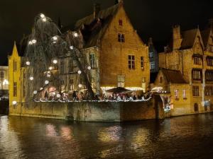 a group of people standing outside of a building next to a river at Beautiful Bruges in Zeebrugge
