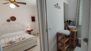 a bedroom with a bed and a mirror and a sink at Welcome to Alberobello in Alberobello