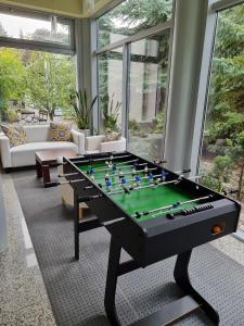 a living room with a foosball table in the middle at Hotel Azyl in Kąty Wrocławskie