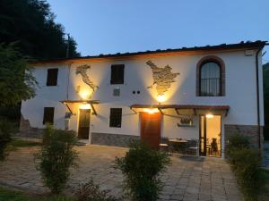 a white building with a table in front of it at Podere Campofossato in Pistoia