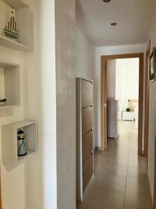 a kitchen with a refrigerator and a hallway at APARTAMENTO PINAPLAYA in Grao de Castellón +40 photos