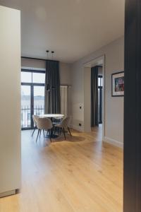 a living room with a dining room table and chairs at Apartments Vitenberg in Cēsis