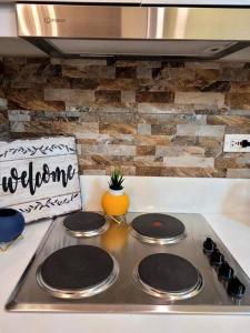 a stove top with four burners in a kitchen at Lady Di Suite in Makati in Manila