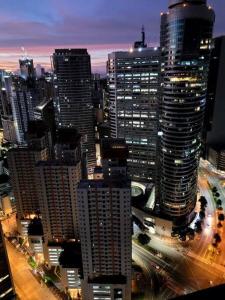 a view of a city at night with tall buildings at Lady Di Suite in Makati in Manila