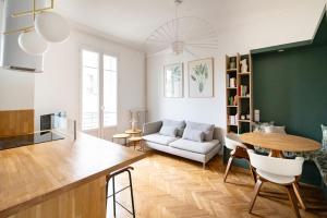a kitchen and living room with a table and a couch at La Maioneta Vieux-Nice in Nice