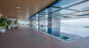 an empty lobby with glass walls and a swimming pool at CĂN HỘ TMS LUXURY RESIDENCES 28 NGUYỄN HUỆ QUY NHƠN in Quy Nhon