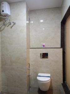 a bathroom with a shower with a toilet and a shower at SAS SQUARE in Tiruchchirāppalli