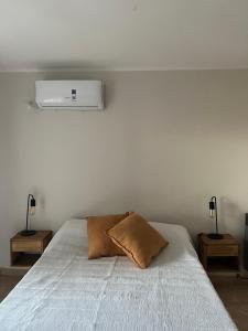 a bedroom with a bed with a pillow on it at Duplex del Río in Concordia +12 photos